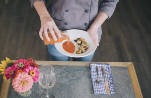 Chef pouring harvest soup table side