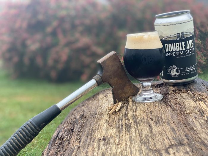 beer posed with axe to promote dirt farm brewing chasin' axe on the mountain