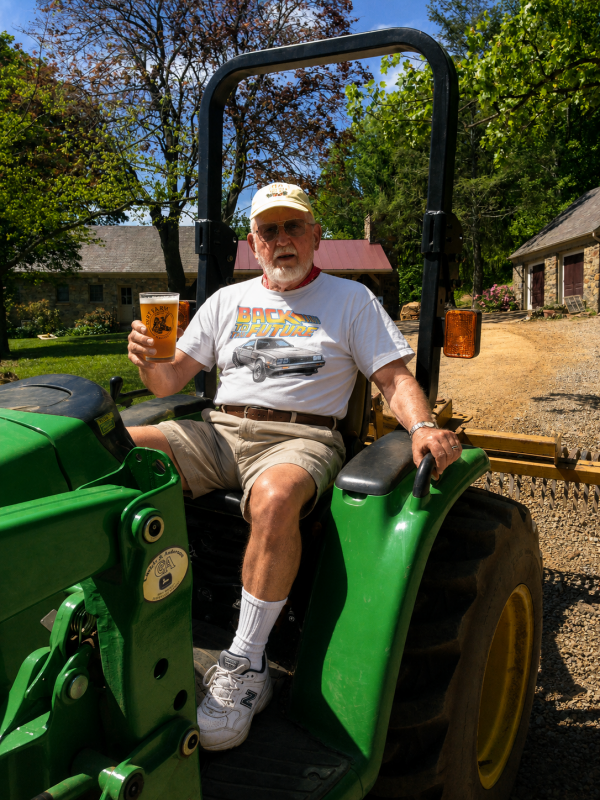 Paw Paw sitting on a tractor celebrating Father's Day at dirt farm brewing