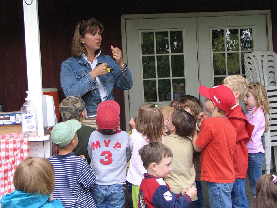 Teacher talking to a group of children at Great Country Farms Teacher Appreciation Days