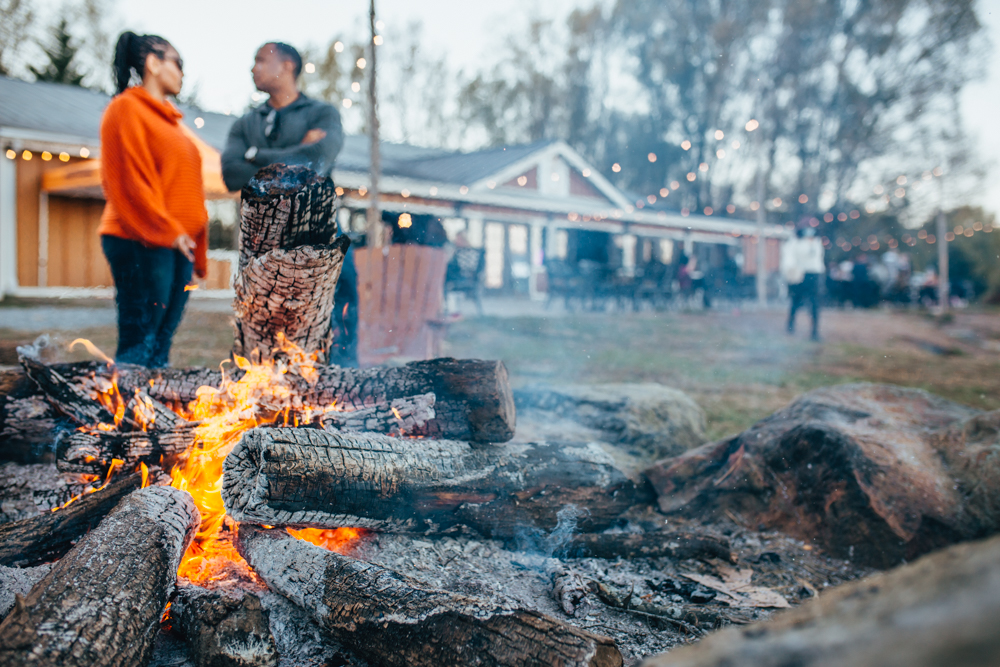 Couple gathered around a fire at Henway Card Hider